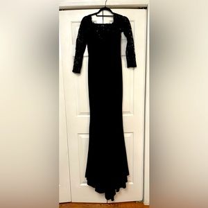 Black lace long sleeve off the shoulder slinky gown with train.